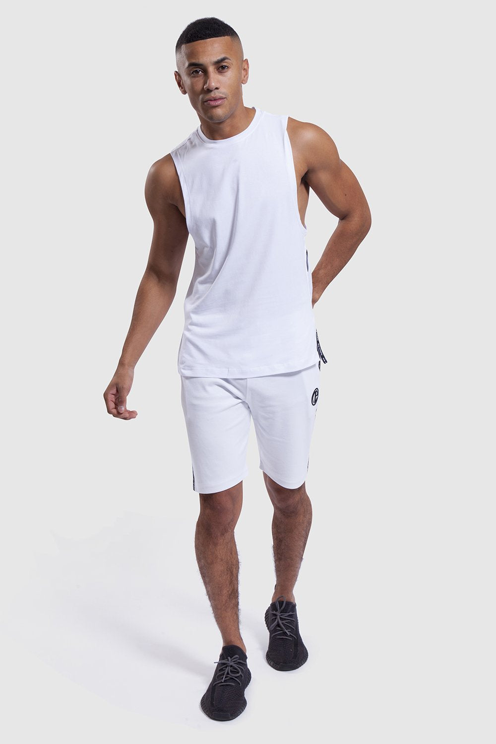 model wearing gym shorts and vest